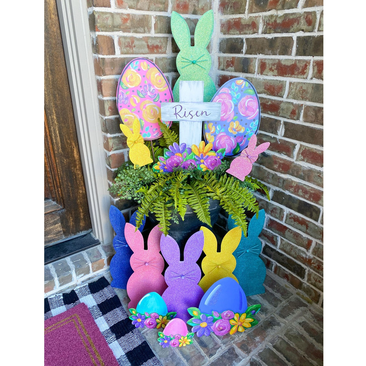 Artful Risen Cross & Flowers metal garden stake with cross silhouette surrounded by floral patterns in earth tones.