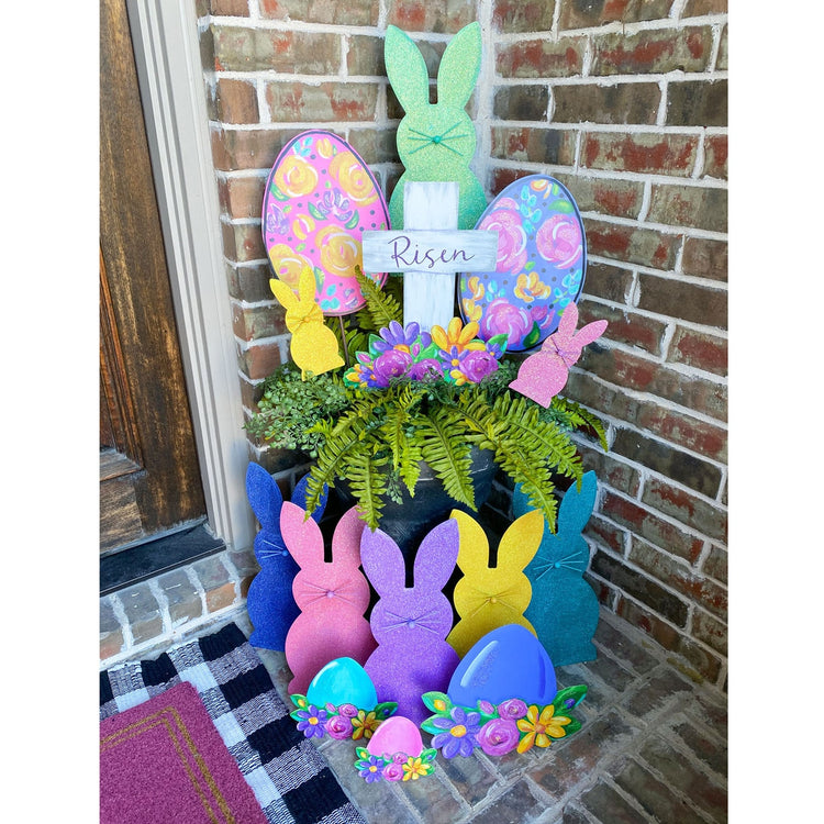 Artful Risen Cross & Flowers metal garden stake with cross silhouette surrounded by floral patterns in earth tones.
