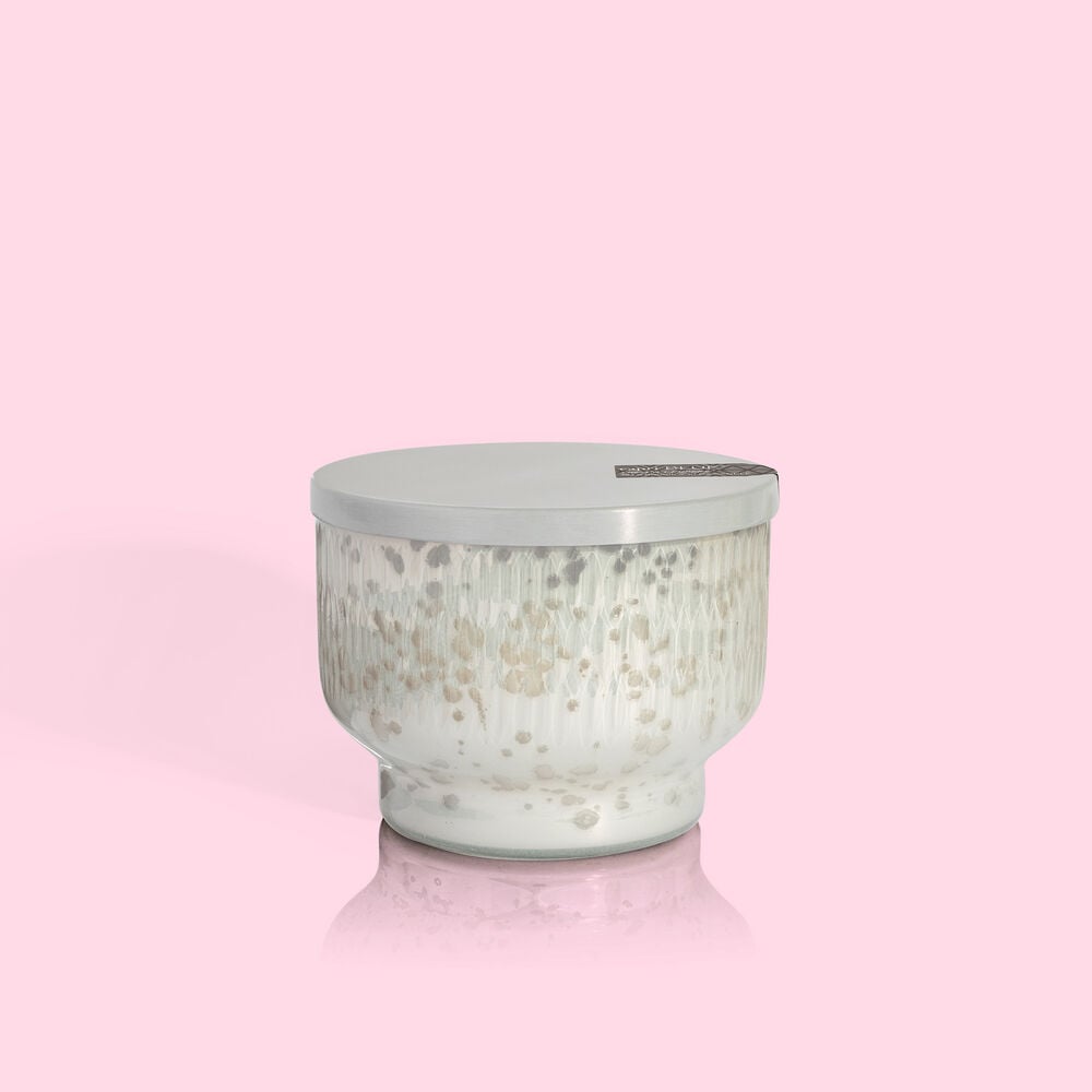 10 oz Chestnut Embers Holiday Mercury Inverted Jar candle with a silver lid on a pink background.