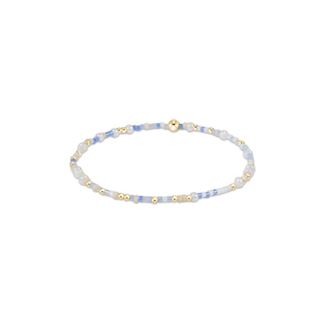 Hope Unwritten bracelet featuring mixed seed beads in various colors with gold-filled accents on elastic cord.