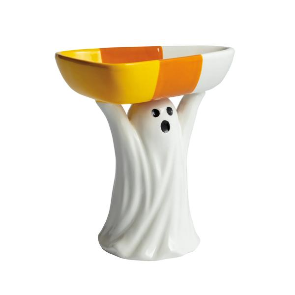 Ceramic ghost figurine holding up a candy corn patterned dish on its head.