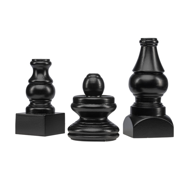 Three small black decorative display poles in varying heights and turned wood shapes.