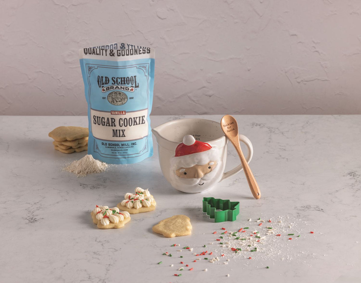 Santa Measuring Cup & Cookie Mix Gift Set with wooden spoon and green tree cookie cutter.