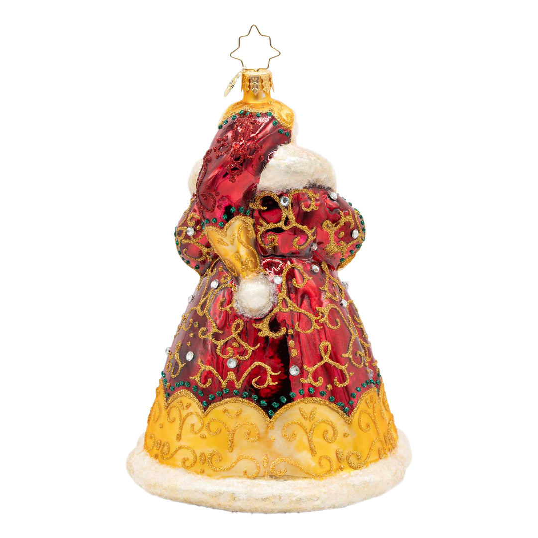 Back view of a red and gold glass Santa ornament with intricate filigree and sparkling jewels.