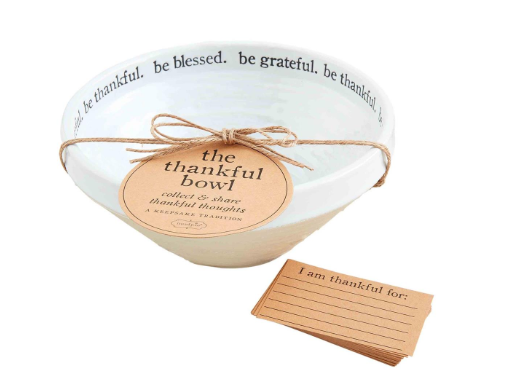 The Thankful Bowl, a white ceramic bowl with black text, tied with twine and a tag, with a stack of 'I am thankful for' cards.