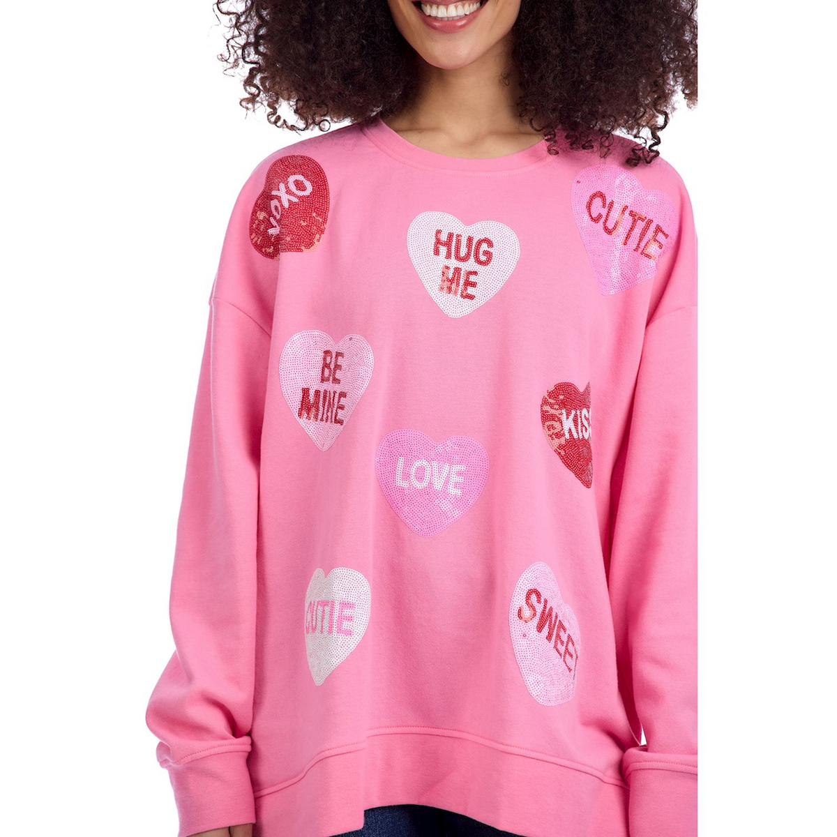 Pink oversized sweatshirt with sequined conversation hearts featuring Valentine's Day phrases.