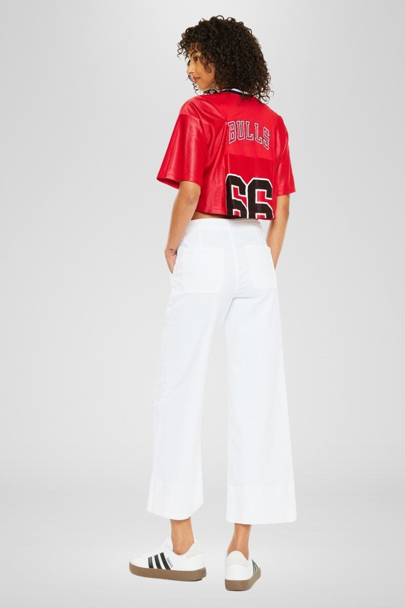 Front view of Patricia high-rise wide-leg cropped jeans in faded denim with slant pockets and zipper fly.