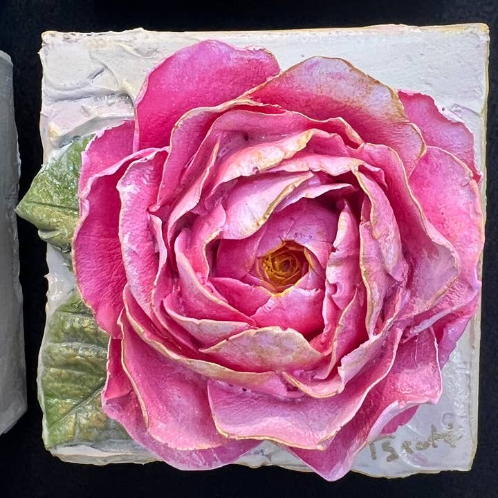 Square clay artwork featuring a rose with textured petals in earthy tones.
