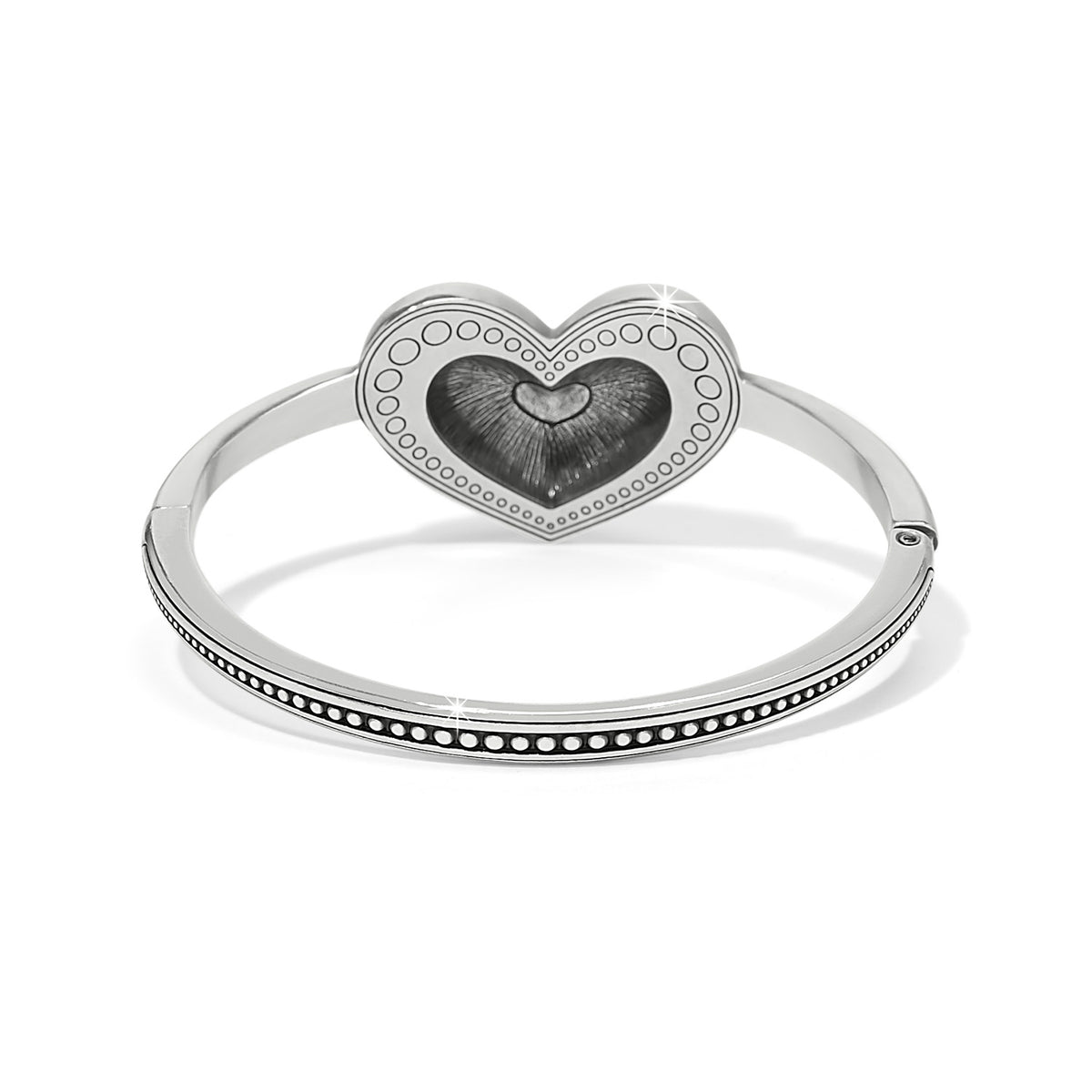 Silver-plated Love Me Do hinged bangle featuring a large heart centerpiece with beaded detailing.