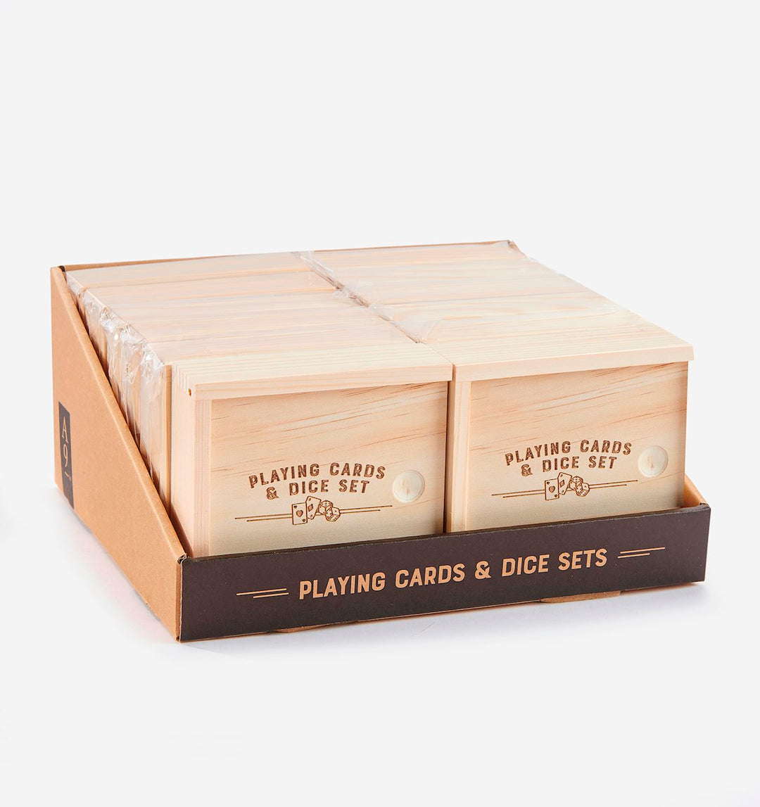A display box containing multiple wooden Playing Cards & Dice Sets with engraved lids.