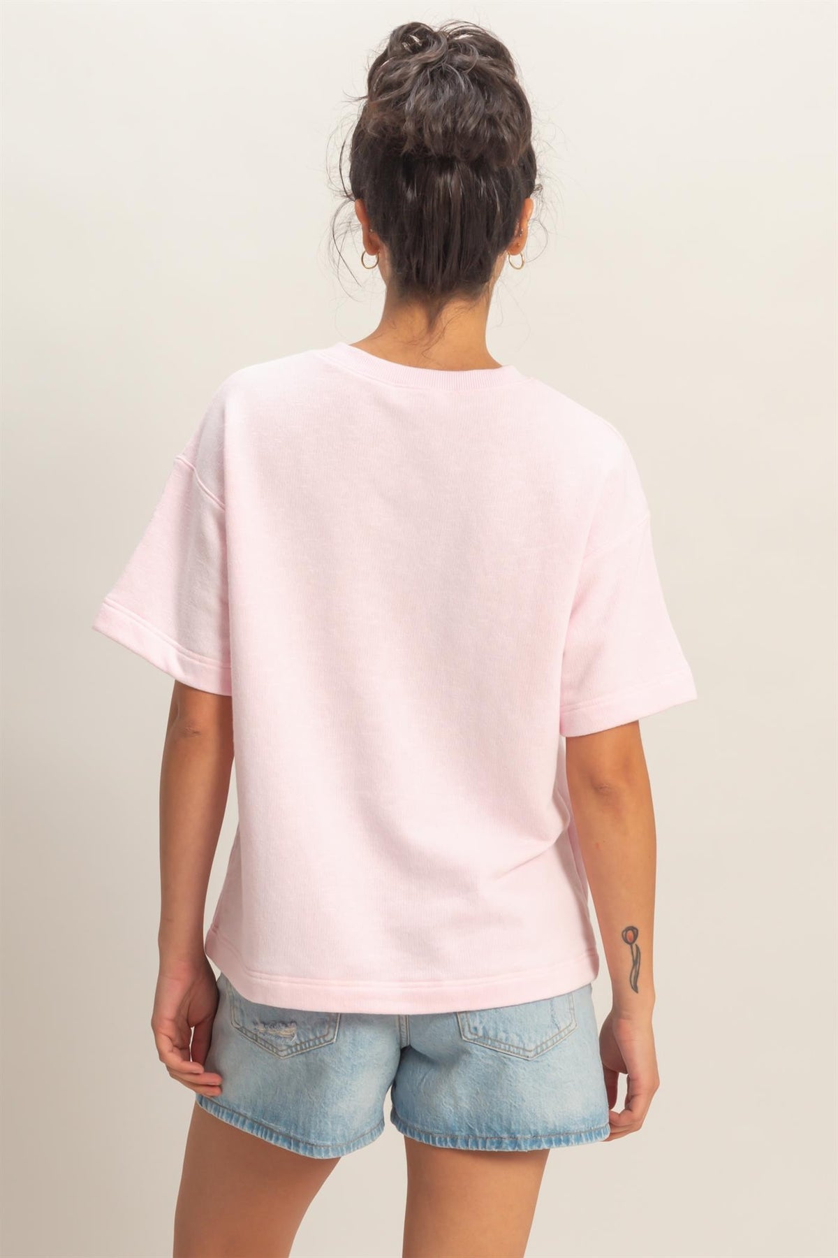 Airine crew neck short sleeve top in light blue with a subtle pattern.