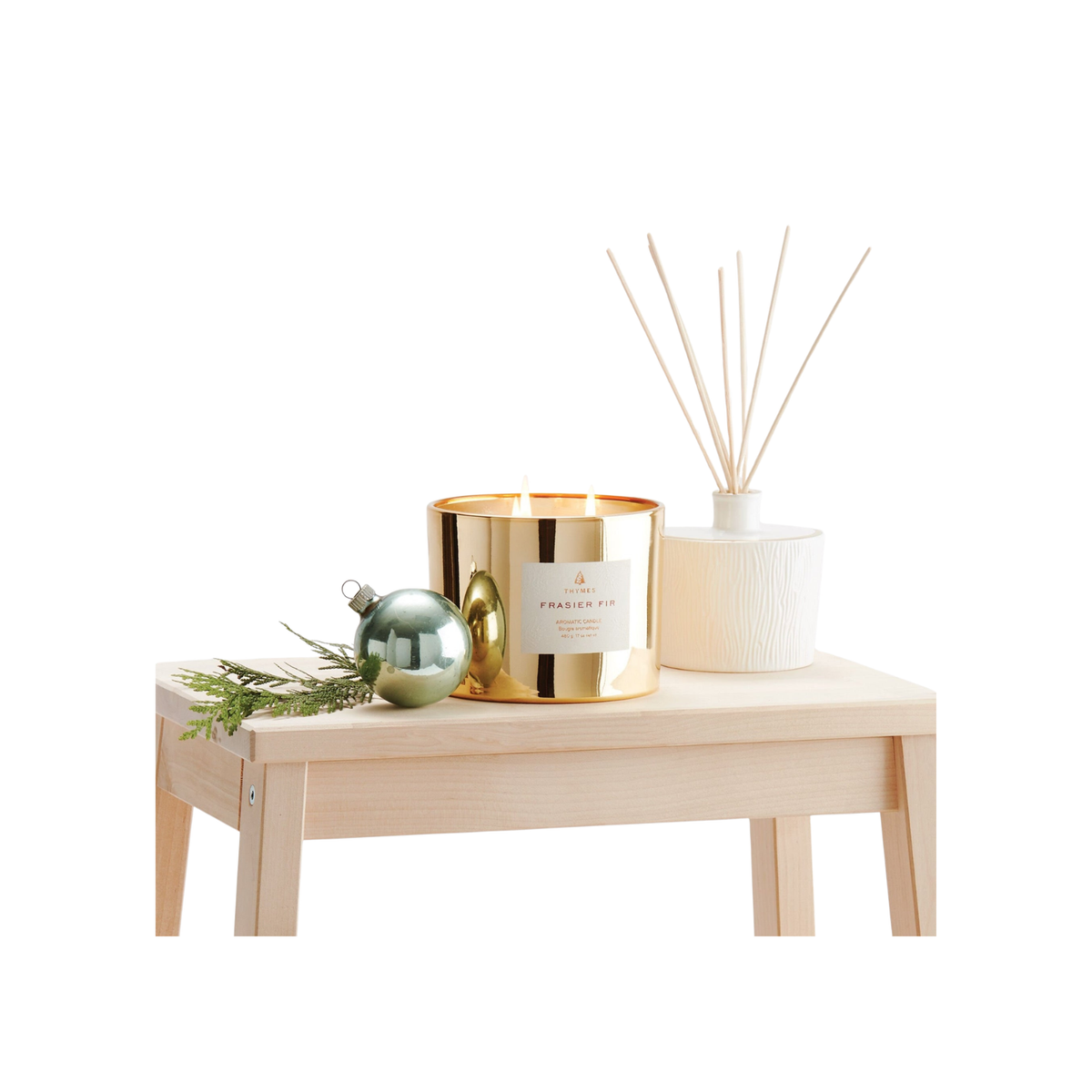 3-Wick Frasier Fir Gilded Poured Candle in a gold jar on a wooden table with holiday decor.
