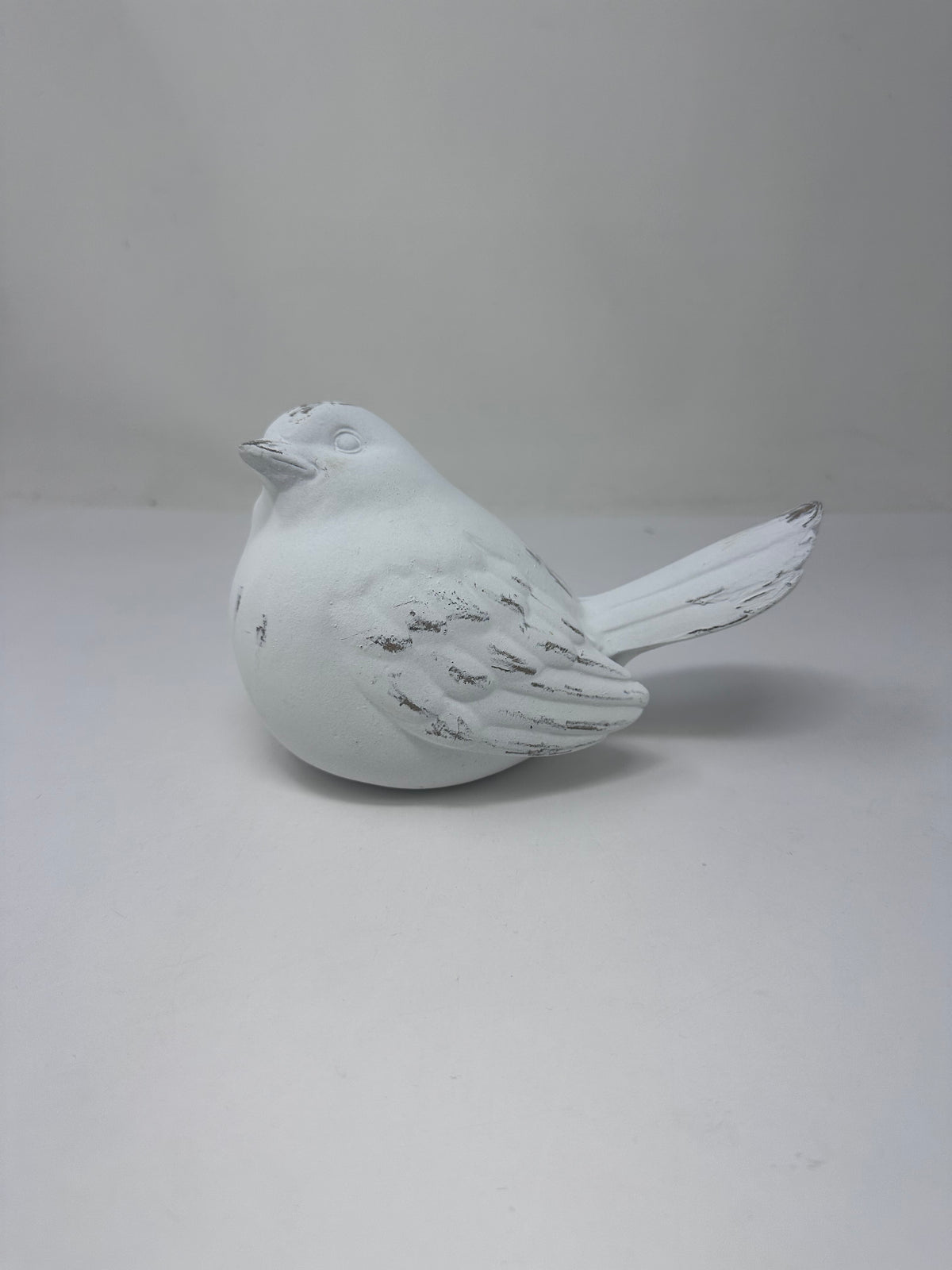 Large whitewashed resin bird figurine with a distressed finish and textured wing details.