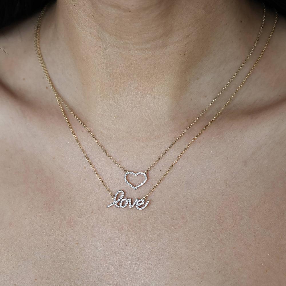 Sterling silver pendant necklace with gold-plated finish featuring a heart-shaped silhouette set with small diamonds.