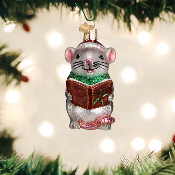 Grey caroling mouse glass ornament holding a brown book with green glitter scarf and pink tail.