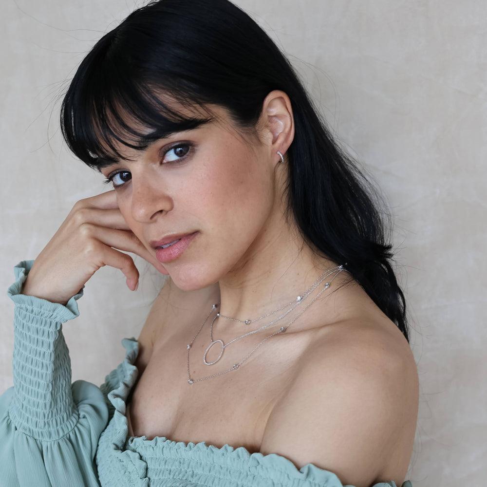 Hinge closure hoop earrings in silver with a gold-plated finish.