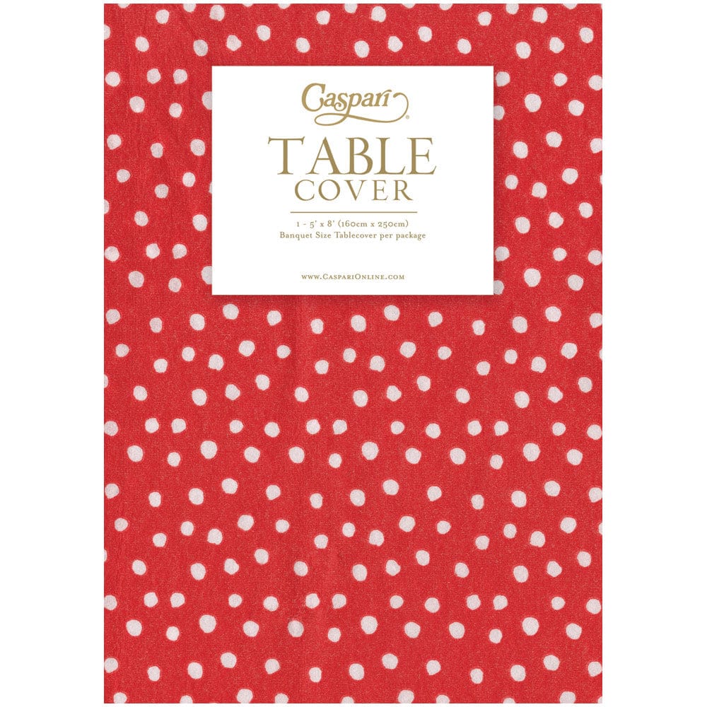 Red paper linen table cover with a white small polka dot pattern and Caspari branding.