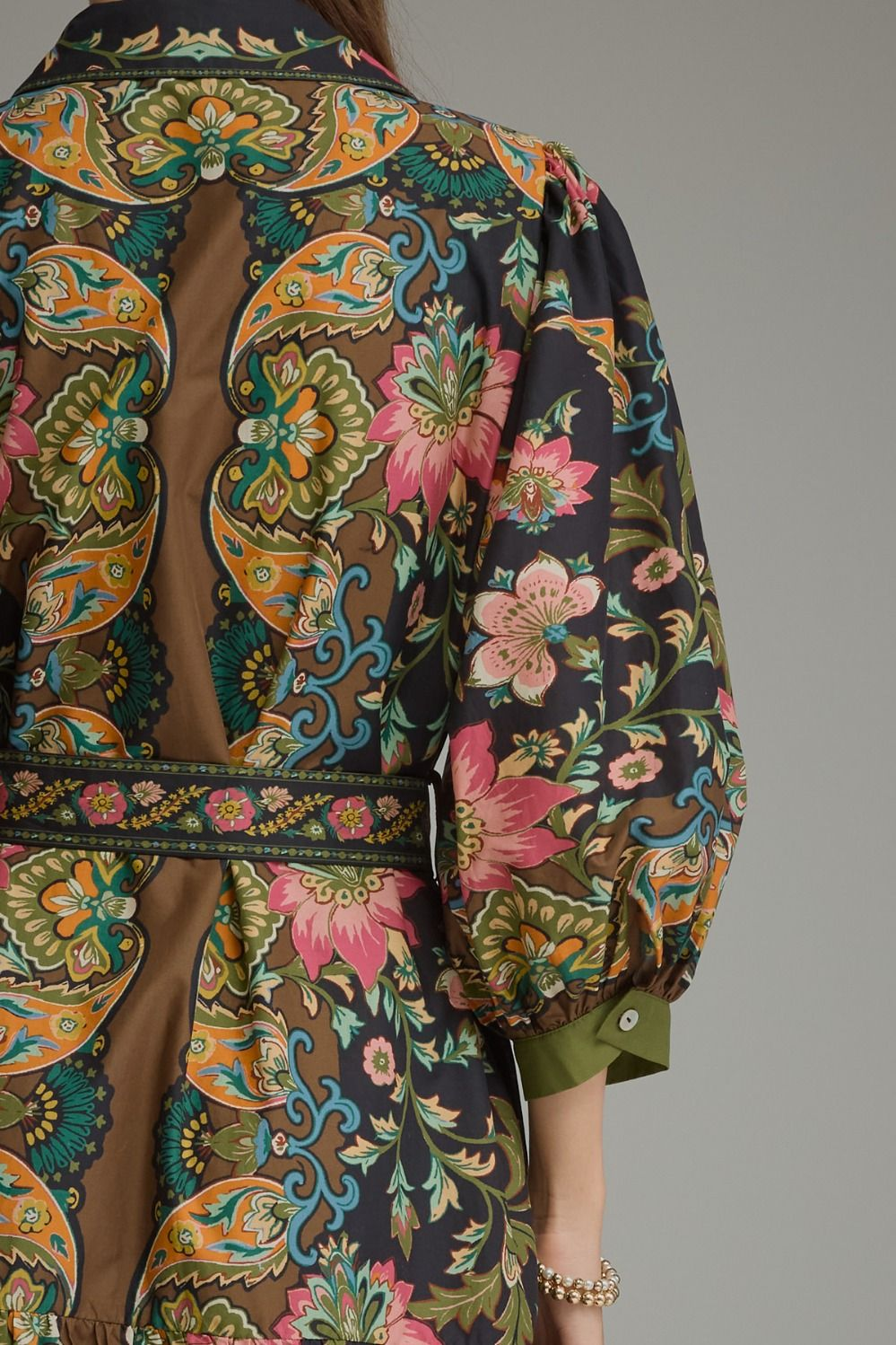 Back view of a midi dress with a colorful paisley and floral print, featuring 3/4 balloon sleeves.