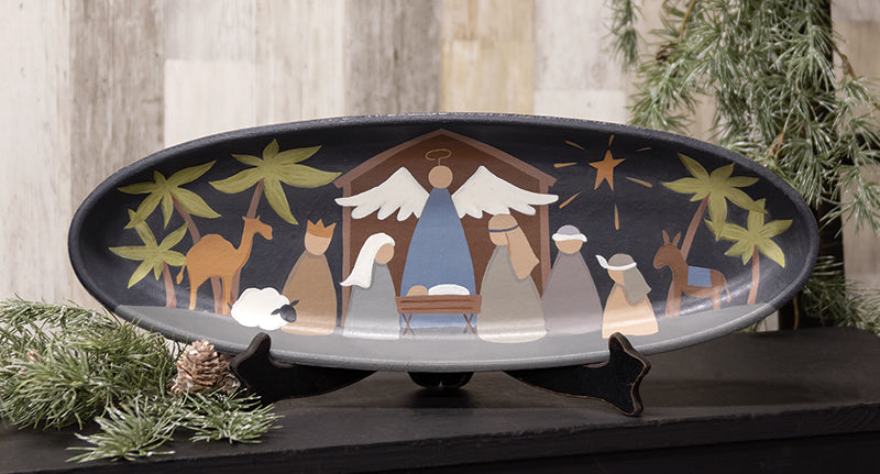 Primitive Nativity scene painted on a black wooden oval tray with a display stand.