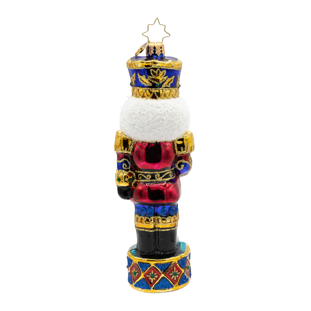 Radiant Jewel Nutcracker glass ornament in ruby, sapphire, and gold with a white glitter beard.