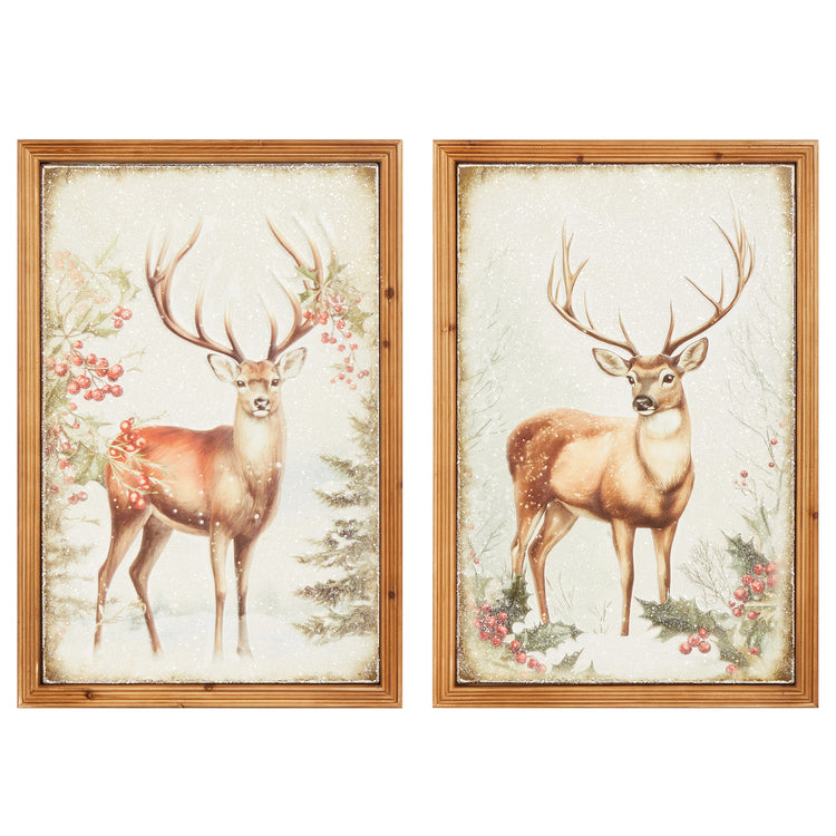 Two framed metal wall art pieces featuring stags in a snowy winter scene with holly and berries.