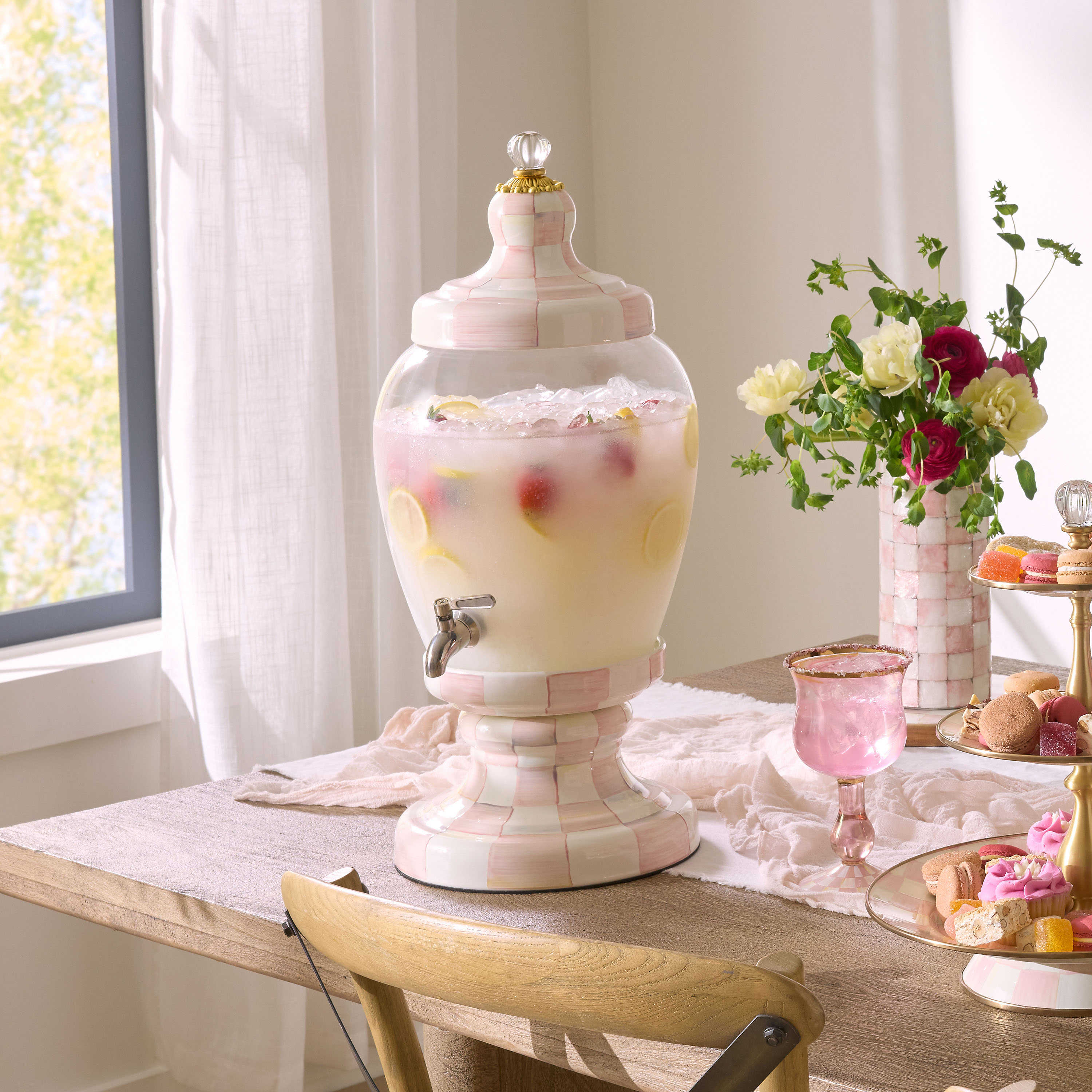 Rosy Check Beverage Hostess with a hand-painted pink and white checkered base and lid on a table.
