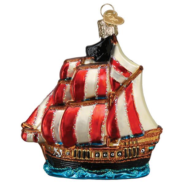 Hand-painted glass pirate ship Christmas ornament with red and white striped sails and glitter.