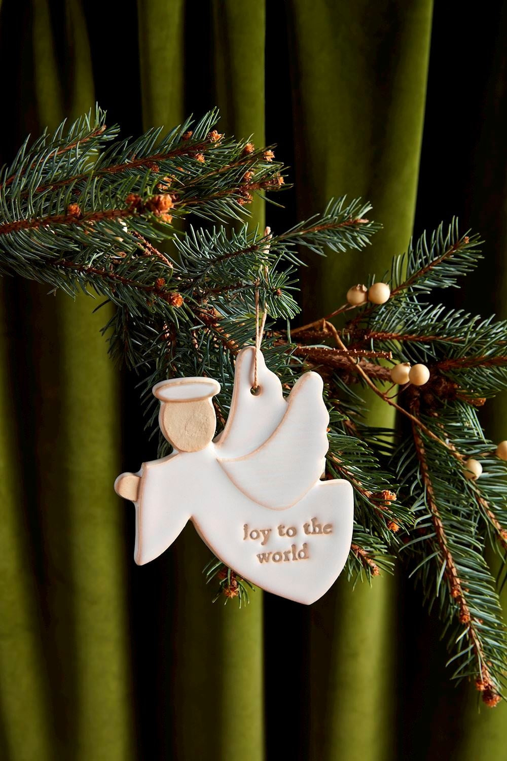 Milk glazed textured stoneware nativity ornament shaped as an angel with antique wash finish.