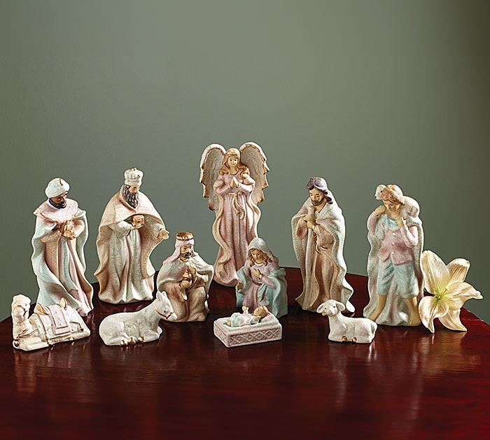 Victorian crackled porcelain nativity set featuring Mary in pink, Joseph in blue, gold accents, and animals.