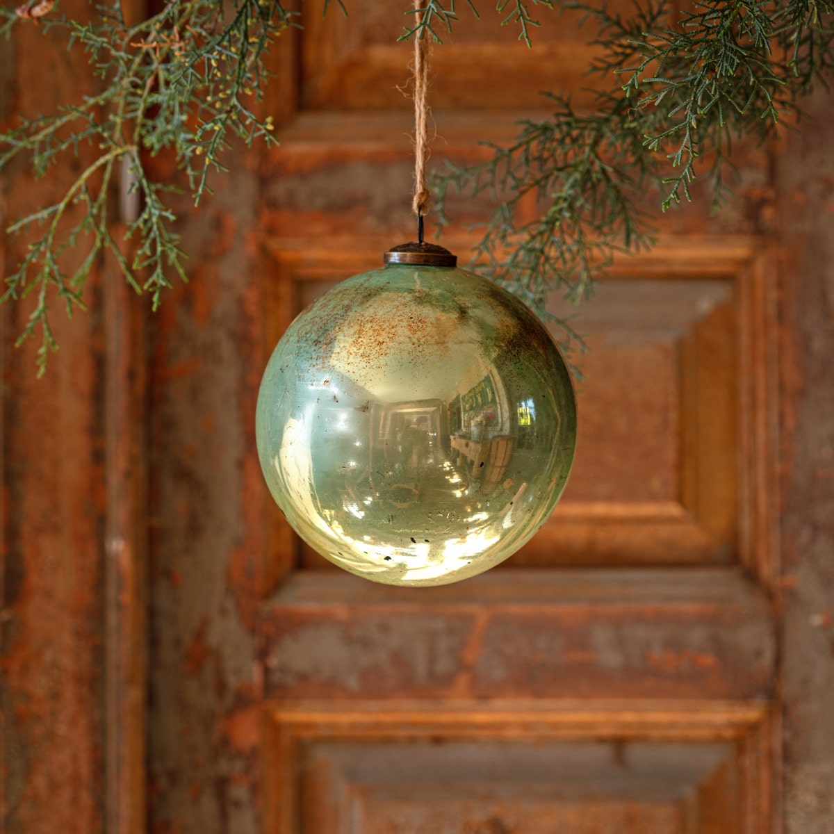 6-inch spruce antique finished glass ball ornament with a natural green hue.
