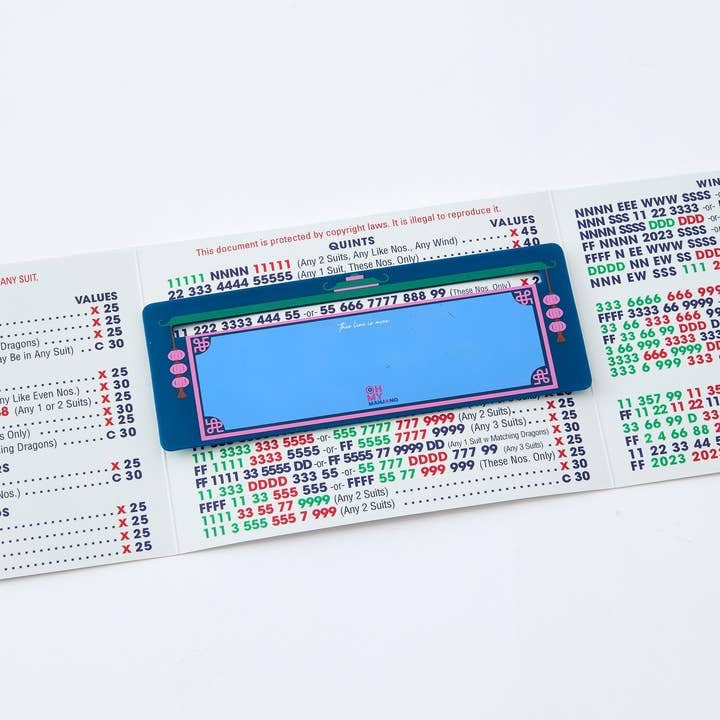 Navy blue plastic Mahjong line finder tool with a curved clip shape.