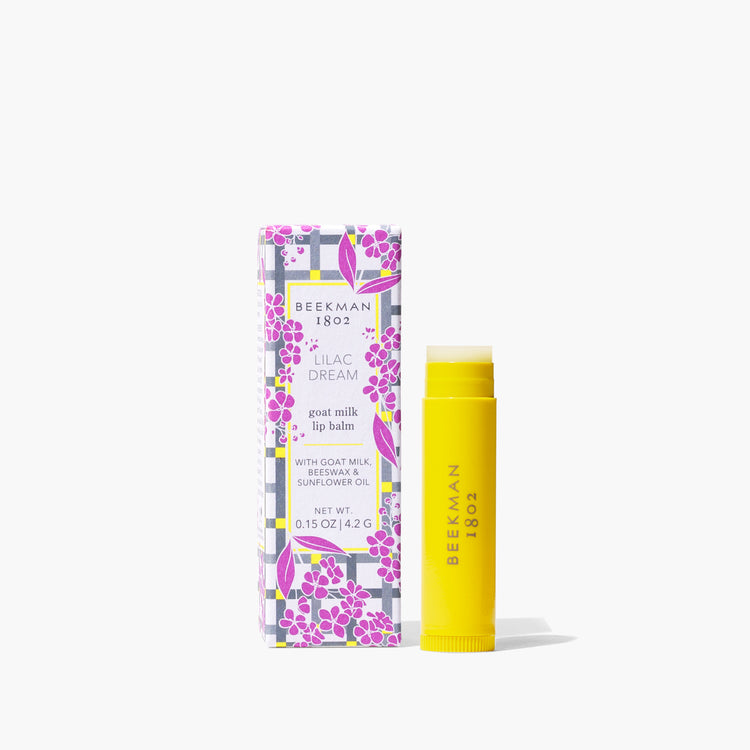 Beekman Lip Balm in a clear tube with gingham patterned paper packaging.
