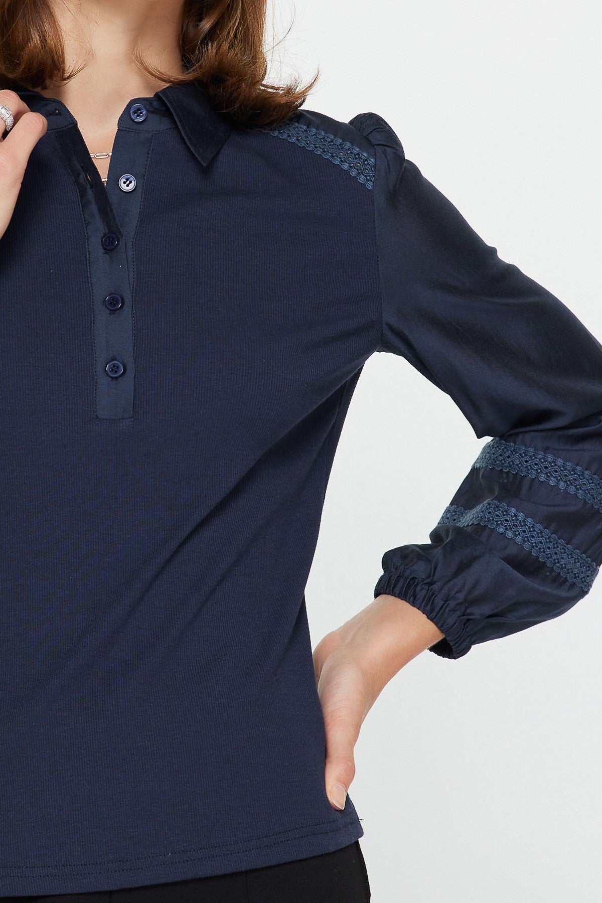 Abigail mixed media polo knit top in soft neutral tone with woven sleeves, lace shoulder trim, and half-button placket.