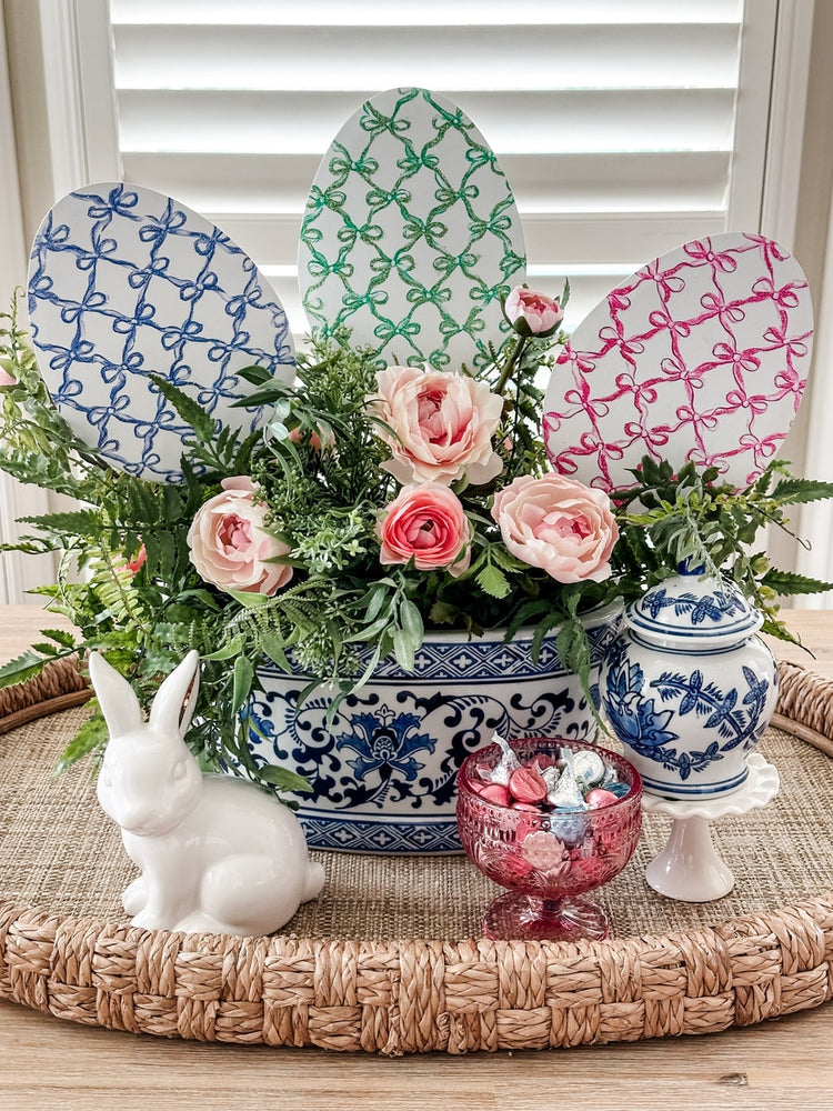 Bowtiful Eggs stake with a large bow on top in pink fabric.