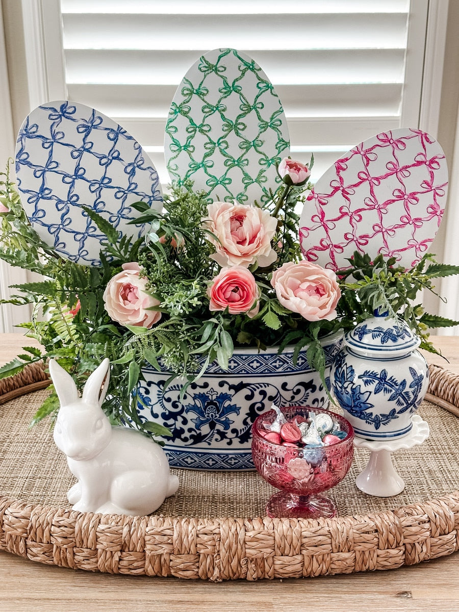 Bowtiful Eggs stake with a large bow on top in pink fabric.