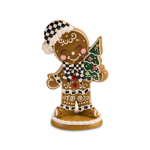 Gingerbread boy figurine wearing a checkered hat and bow tie, holding a small Christmas tree.