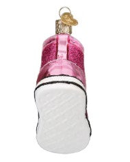 Bottom view of a pink glittery fashion sneaker glass Christmas ornament with a white sole.