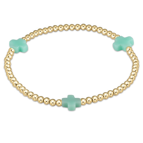 3mm gold-filled bead bracelet featuring a signature cross pendant on stretch elastic cord.