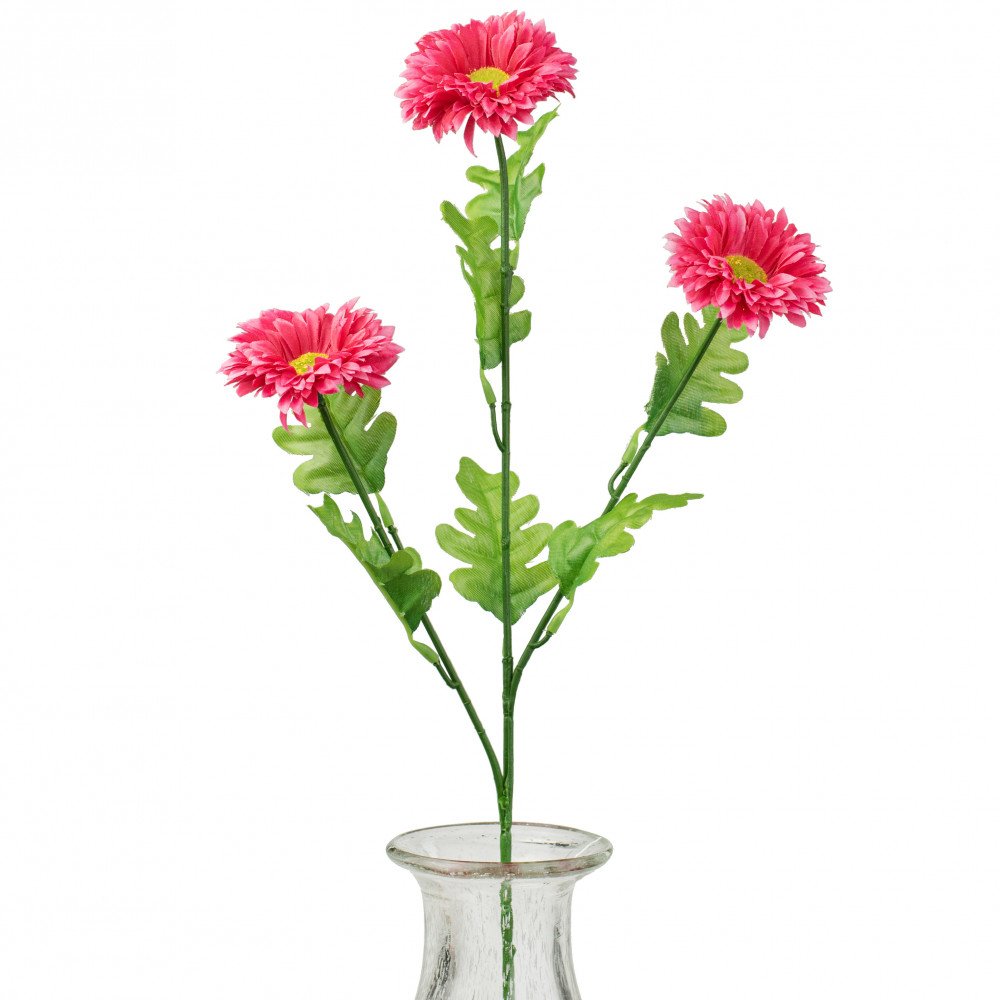 Artificial pink gerbera daisy spray with green leaves in a clear glass vase.