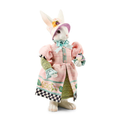 Resin garden statue of a rabbit in spring foliage