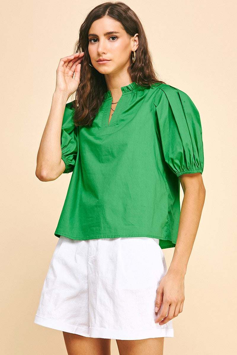 Ivy short sleeve woven top in natural cotton with V-neckline, puff sleeves, and ruffle detailing at the neck.