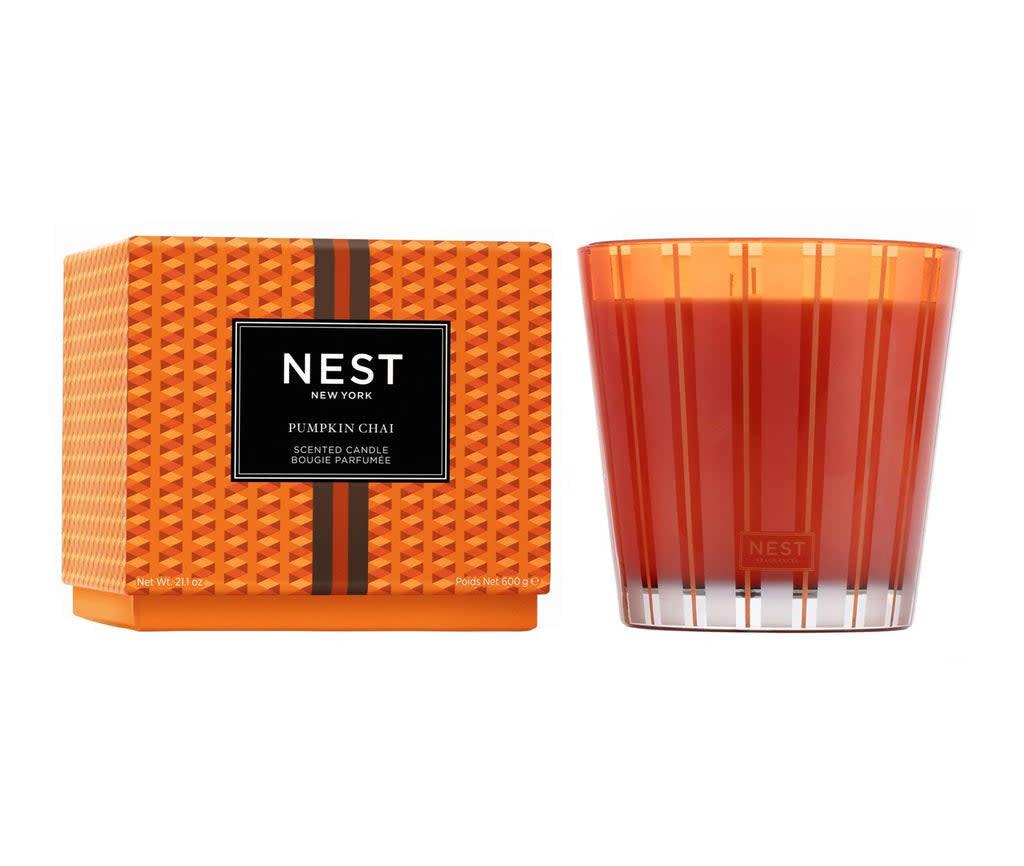 Nest 3-Wick candle in pumpkin chai scent with a warm amber glass jar and three wicks.
