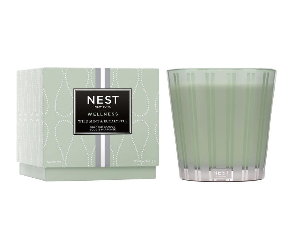 Nest Wild Mint Eucalyptus three-wick candle in a clear glass jar with white wax and black wicks.