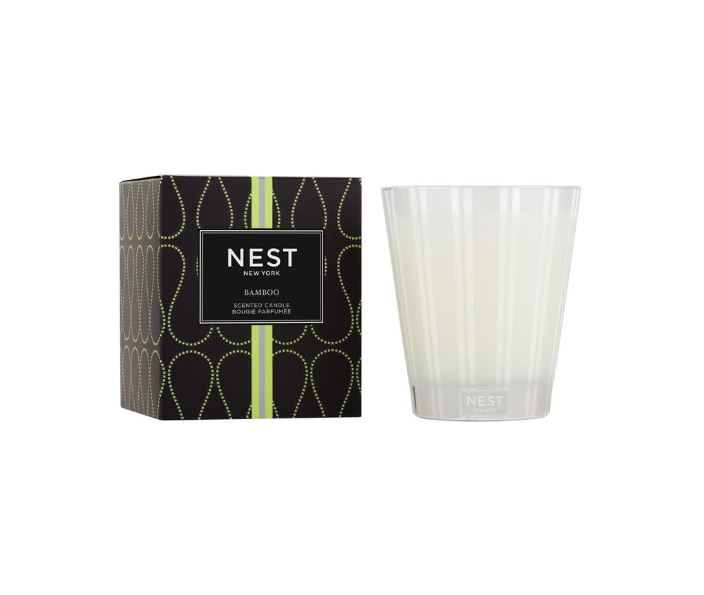 Nest Classic Candle in a natural bamboo holder with an off-white wax pool.
