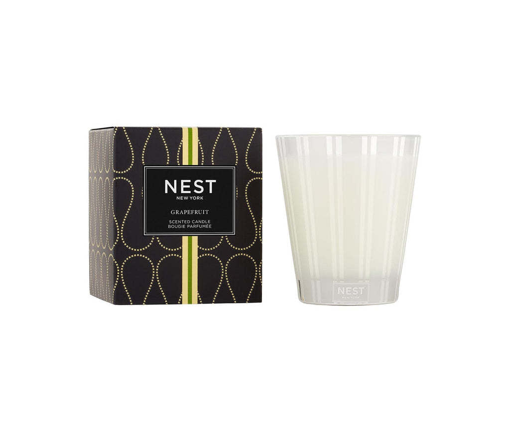 Nest Classic Candle in Grapefruit scent housed in a simple cylindrical glass jar with a white wax pool.