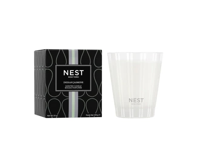 Nest Classic Candle in Indian Jasmine scent housed in a simple white cylindrical glass jar with a black wick.