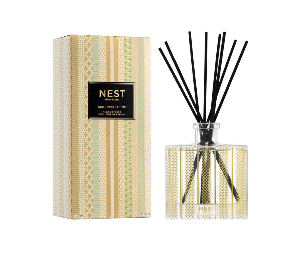 Glass Nest Reed Diffuser with gold leaf etched pattern holding birchwood pine scented oil and rattan reeds