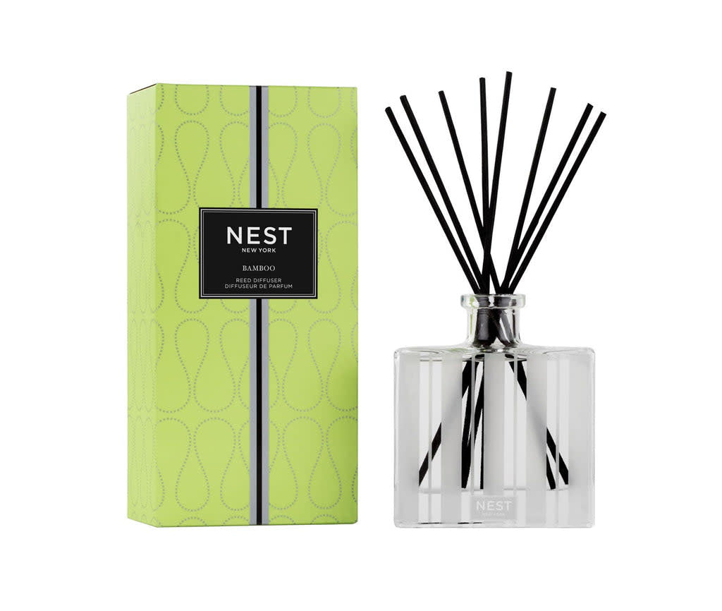 Glass Nest Reed Diffuser with gold leaf etched pattern holding eight rattan reeds