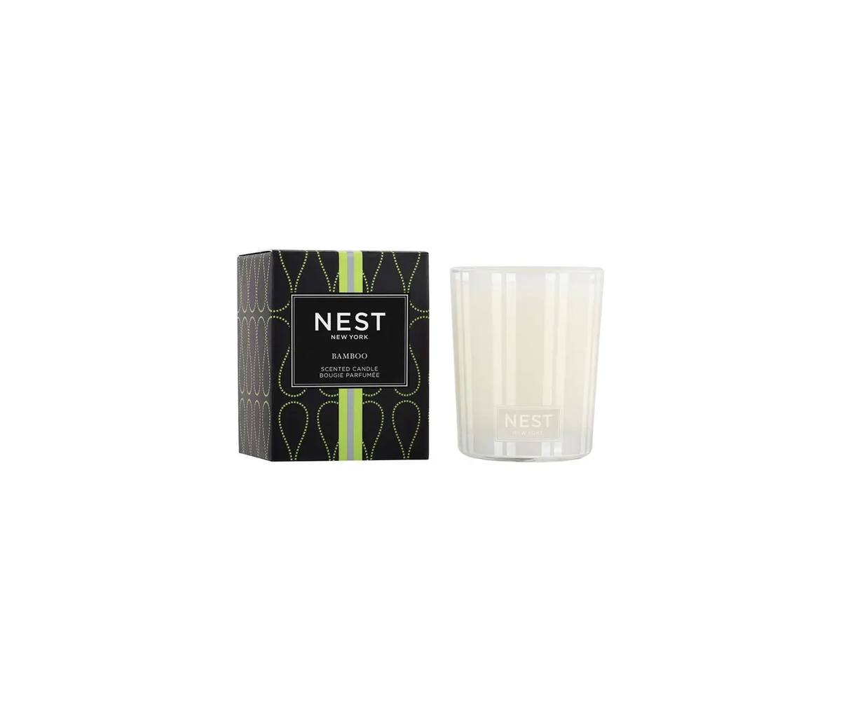 Nest votive candle in a bamboo holder with an off-white wax pool.