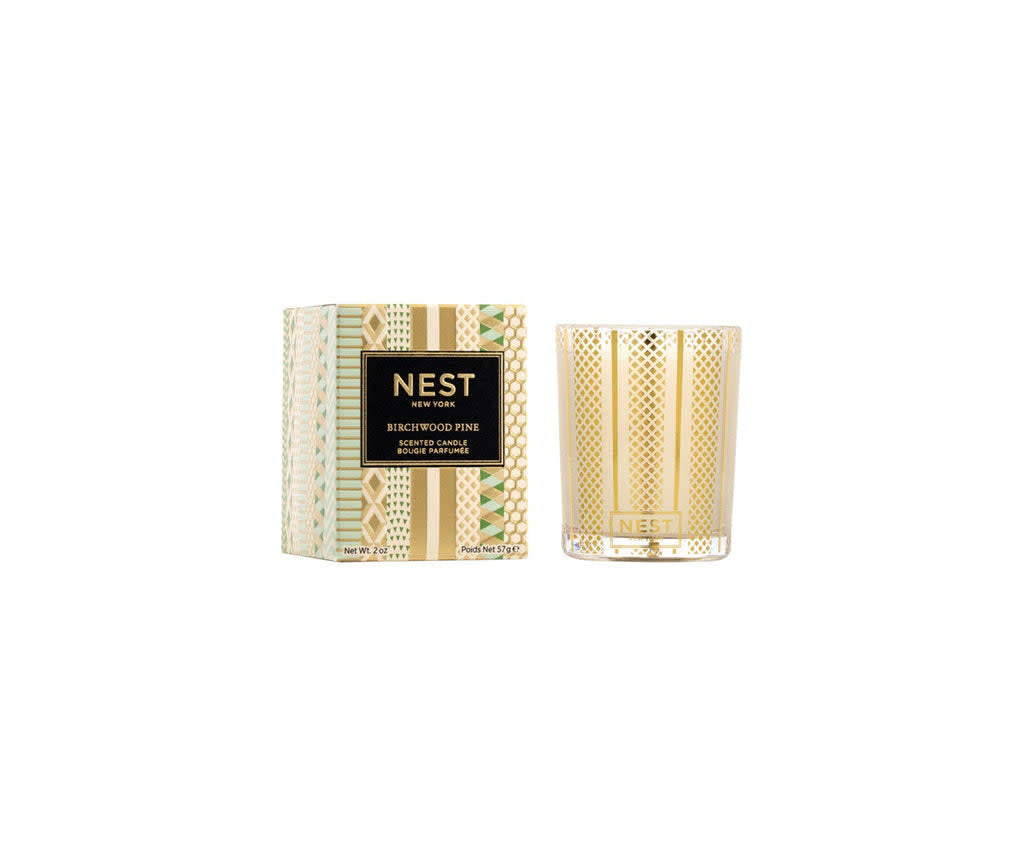 Nest Votive Candle in Birchwood Pine scent with a creamy off-white wax and smooth cylindrical silhouette.
